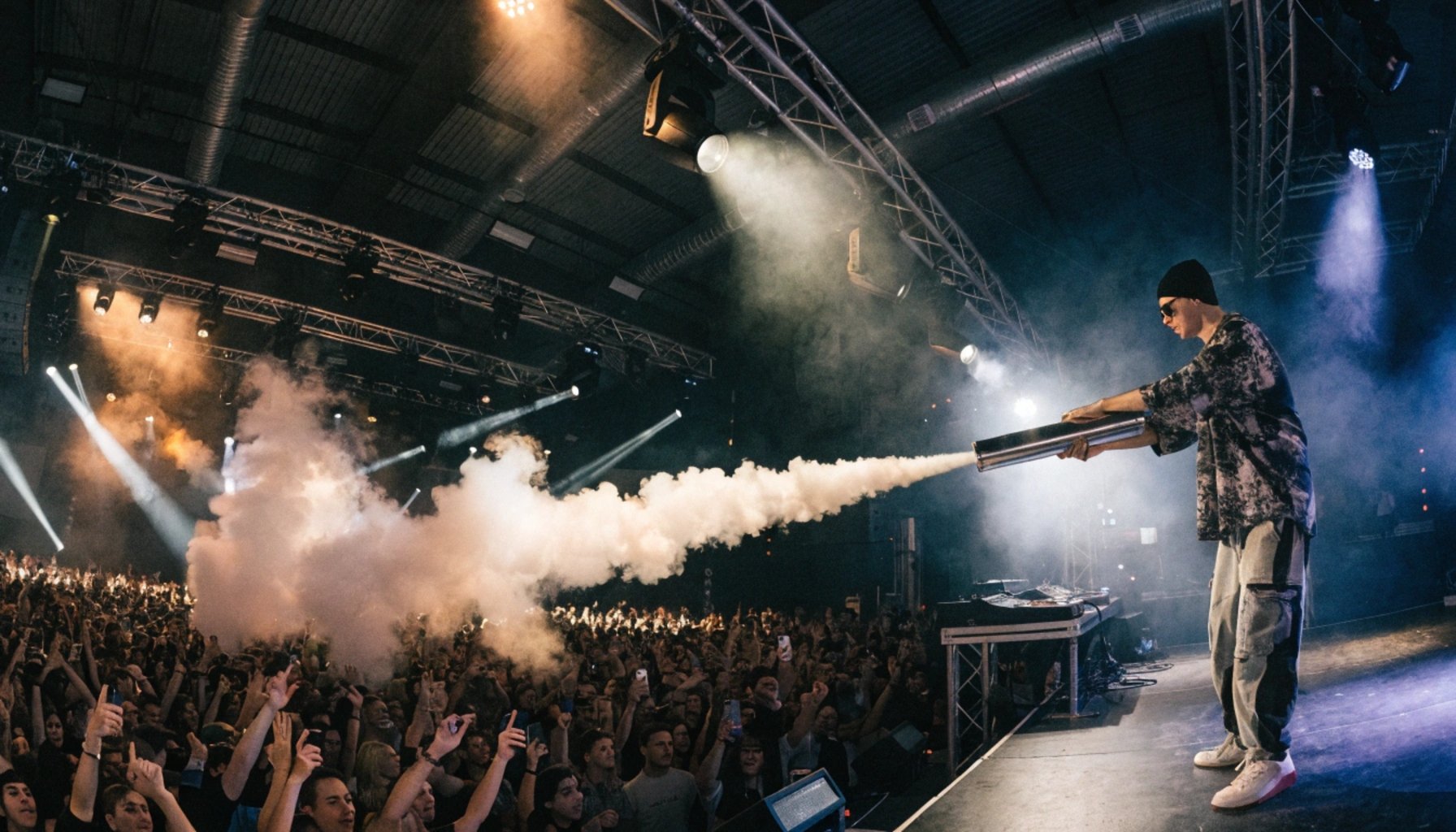 DJ using CO2 cannon on concert stage with crowd and smoke effects