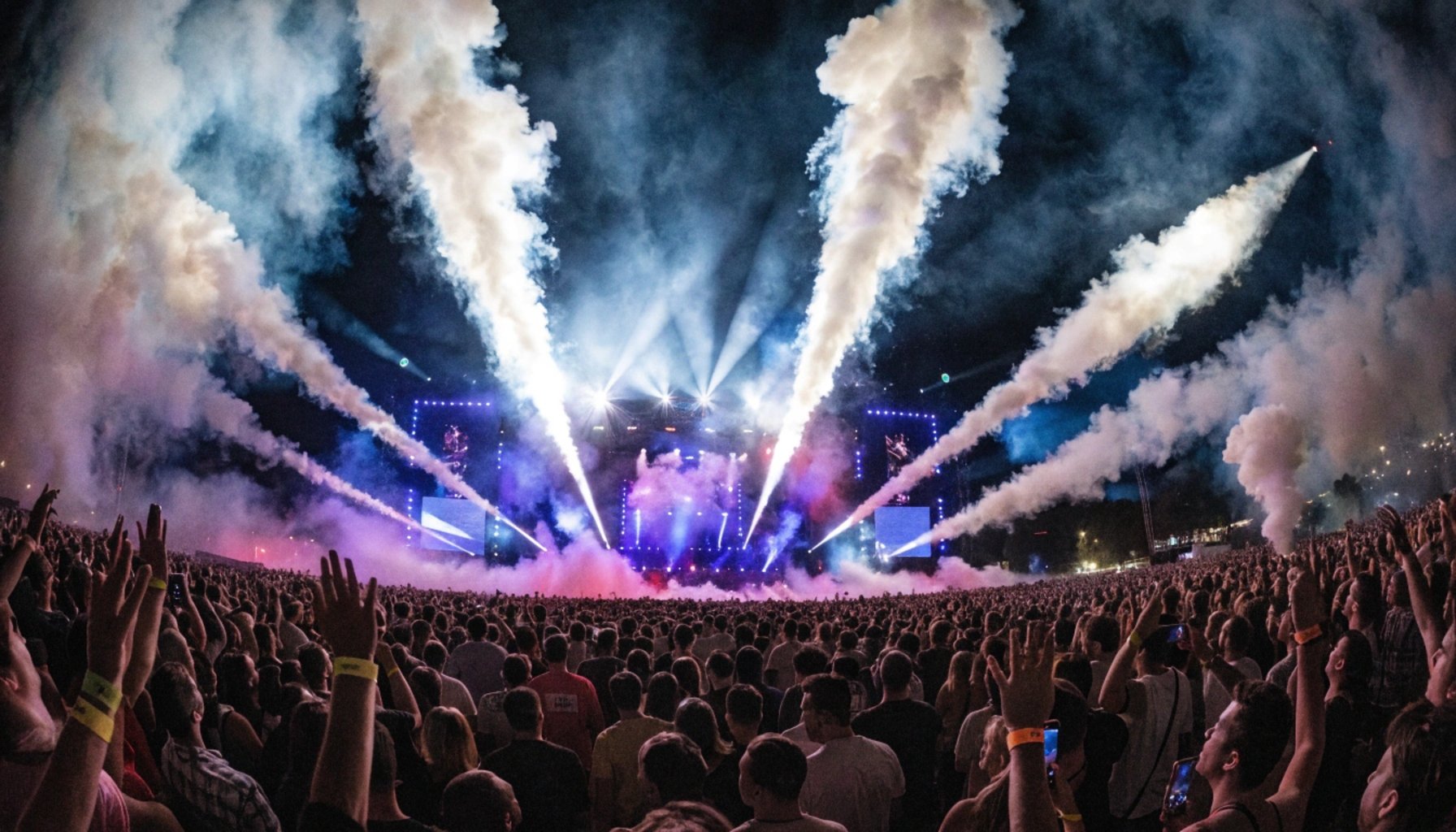 massive outdoor concert stage with LED screens and crowd light show